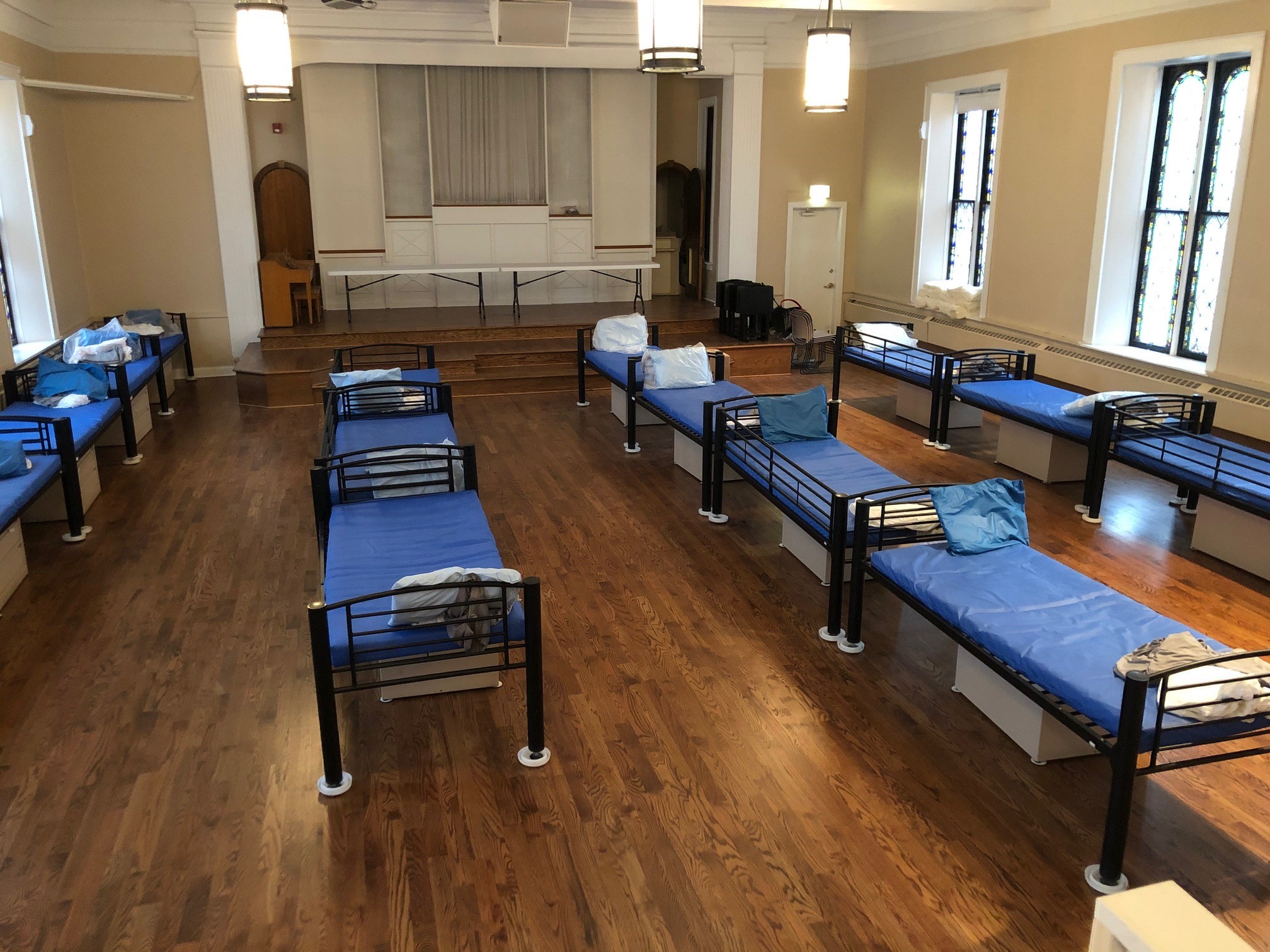 Room with evenly spaced blue cots